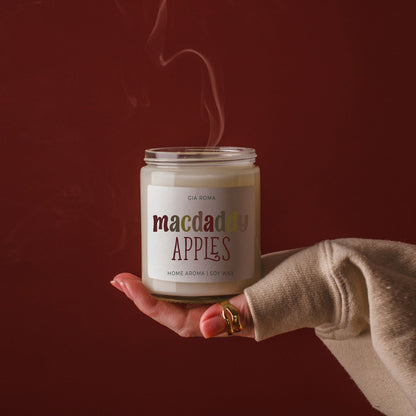 Mac Apple Candle Gia Roma, soy wax jar with colorful macdaddy apples label, held in hand on Tampa Home & Garden Store