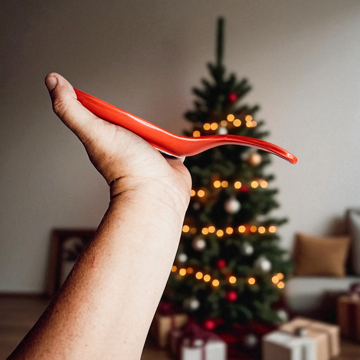 Gia Roma Holiday Hot Mess Stop silicone spoon rest held in hand Christmas tree backdrop on Tampa Home & Garden Store