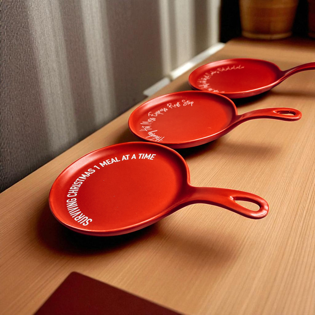 Holiday Hot Mess Stop red spoon rests, Gia Roma 3-piece set with white script around rims on Tampa Home & Garden Store