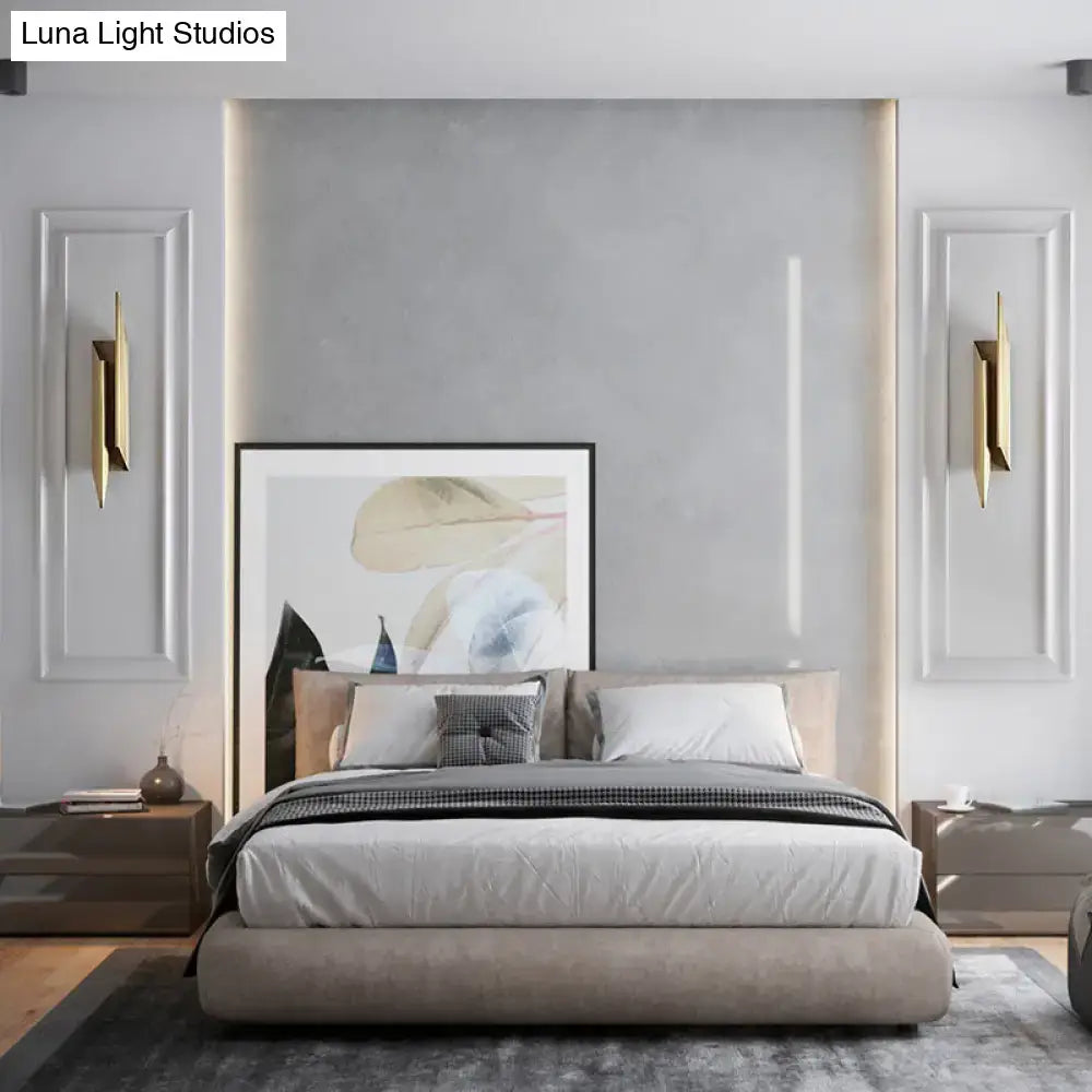 Gold geometric wall sconces by Decorbites, pair on a gray paneled wall beside a bed on Tampa Home & Garden Store