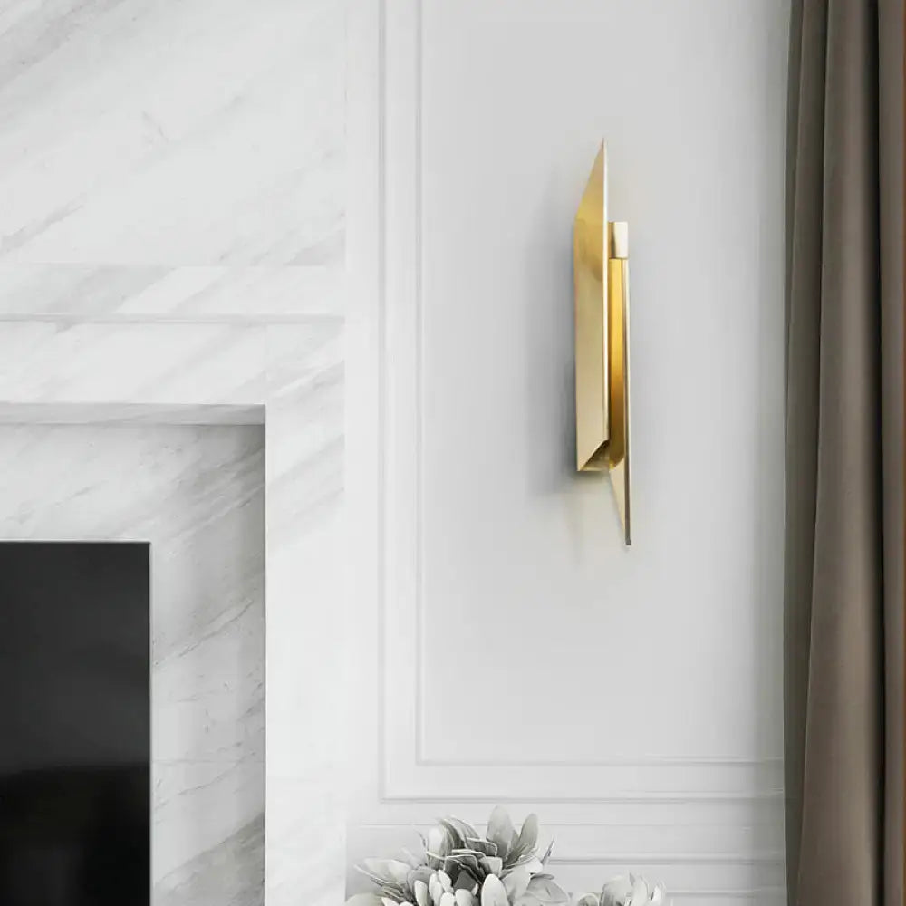 Gold geometric wall sconce by Decorbites mounted on white wall beside curtain on Tampa Home & Garden Store