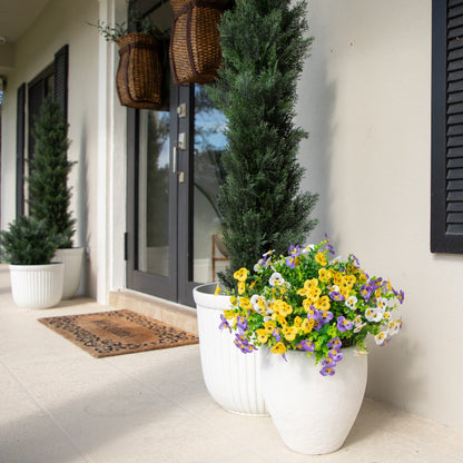 Artificial pansy bush with yellow purple white blooms in a planter; evergreen shrubs flank porch on Tampa Home & Garden Store