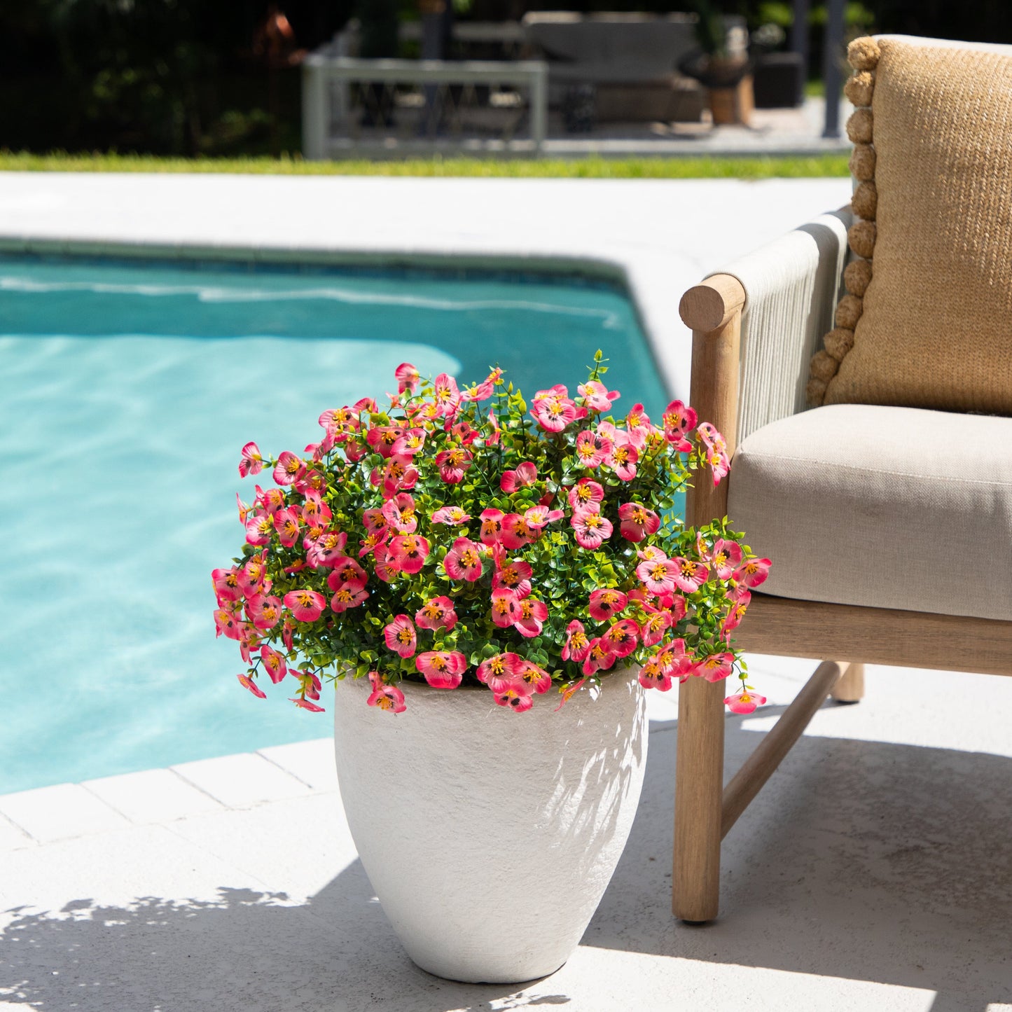 Artificial pansy bush 13in UV resistant pink blooms set of 12 in white planter by poolside on Tampa Home & Garden Store