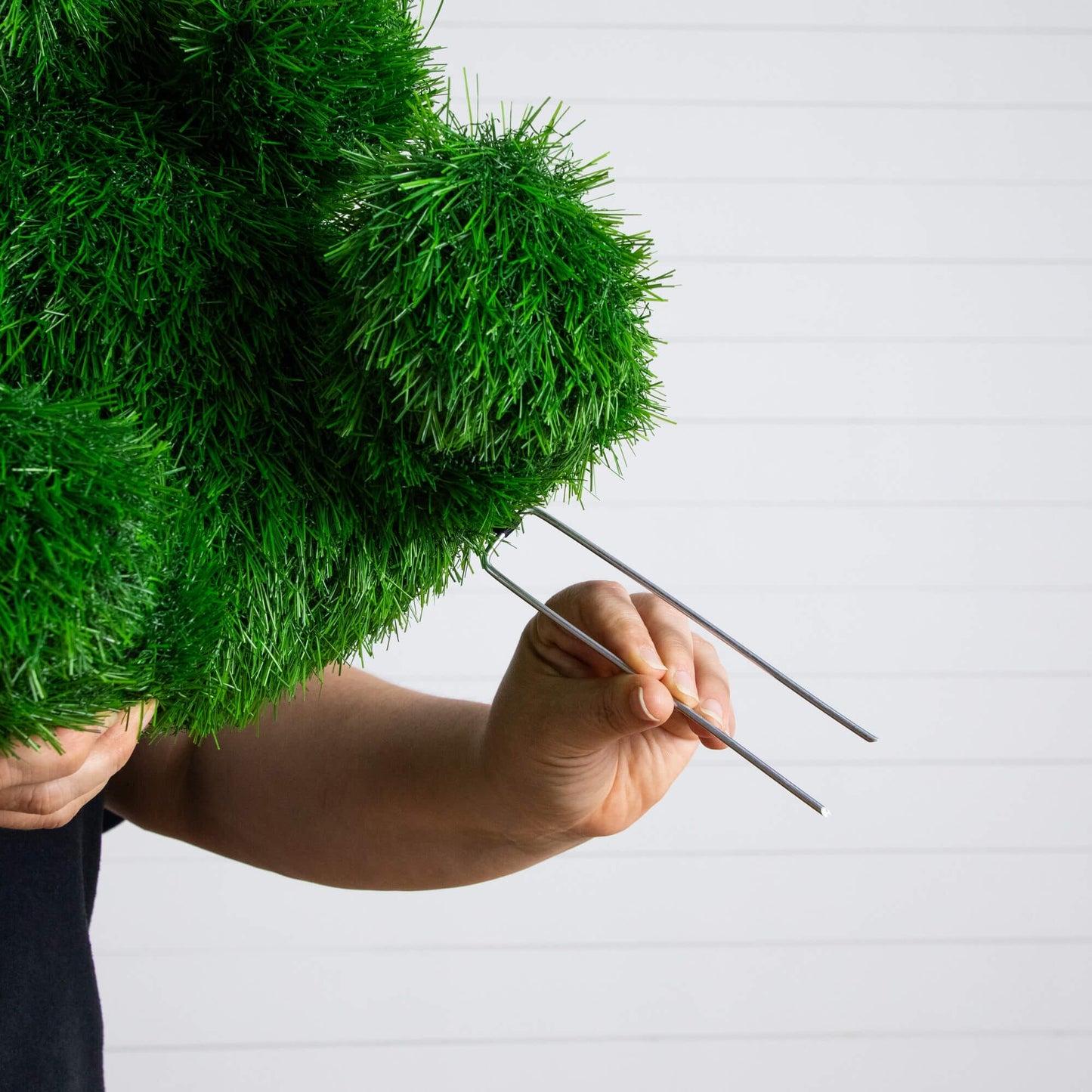 Nearly Natural 14in UV-resistant artificial grass topiary ball, indoor/outdoor, being trimmed by hand on Tampa Home & Garden Store