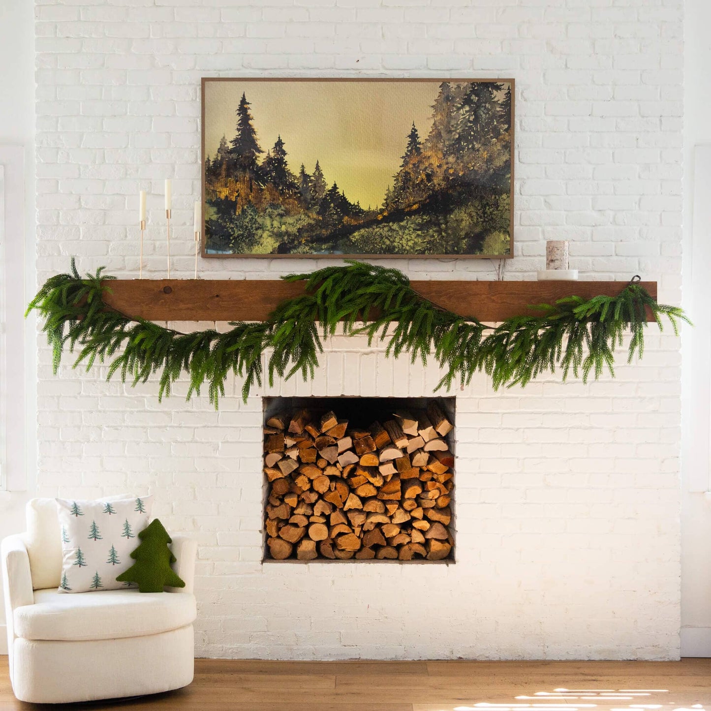 15' Nearly Natural Norfolk Island Pine Garland on a mantle above a white brick fireplace on Tampa Home & Garden Store