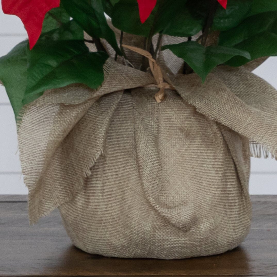 16-inch artificial poinsettia arrangement in burlap wrapped planter with red blooms Nearly Natural on Tampa Home & Garden Store