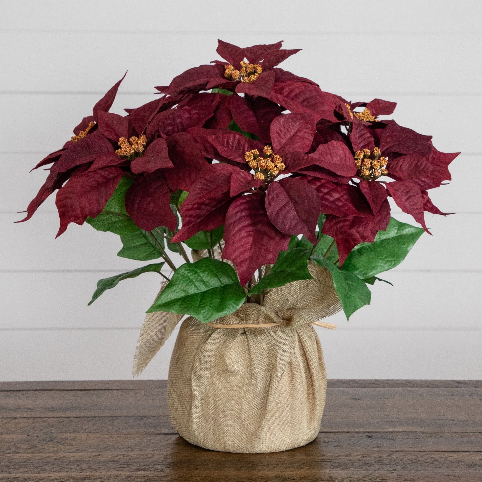 16-inch artificial poinsettia arrangement in burlap planter with red bracts and green leaves Nearly Natural on Tampa Home & Garden Store