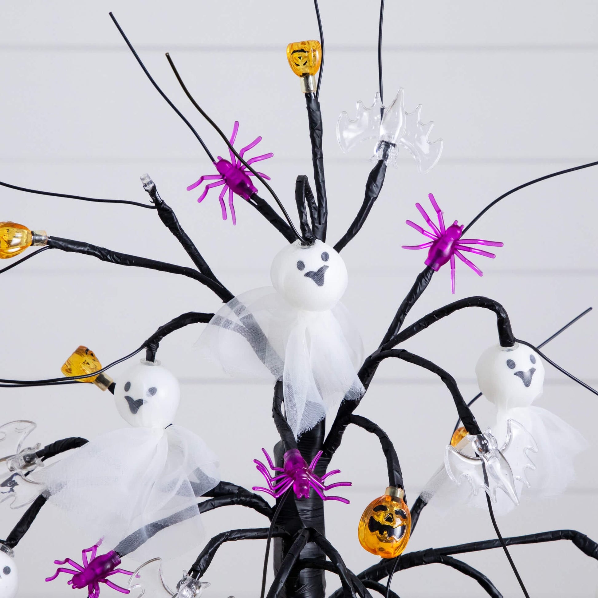 18in pre-lit Halloween ornament tree with white ghost heads, purple spiders, pumpkins on Tampa Home & Garden Store