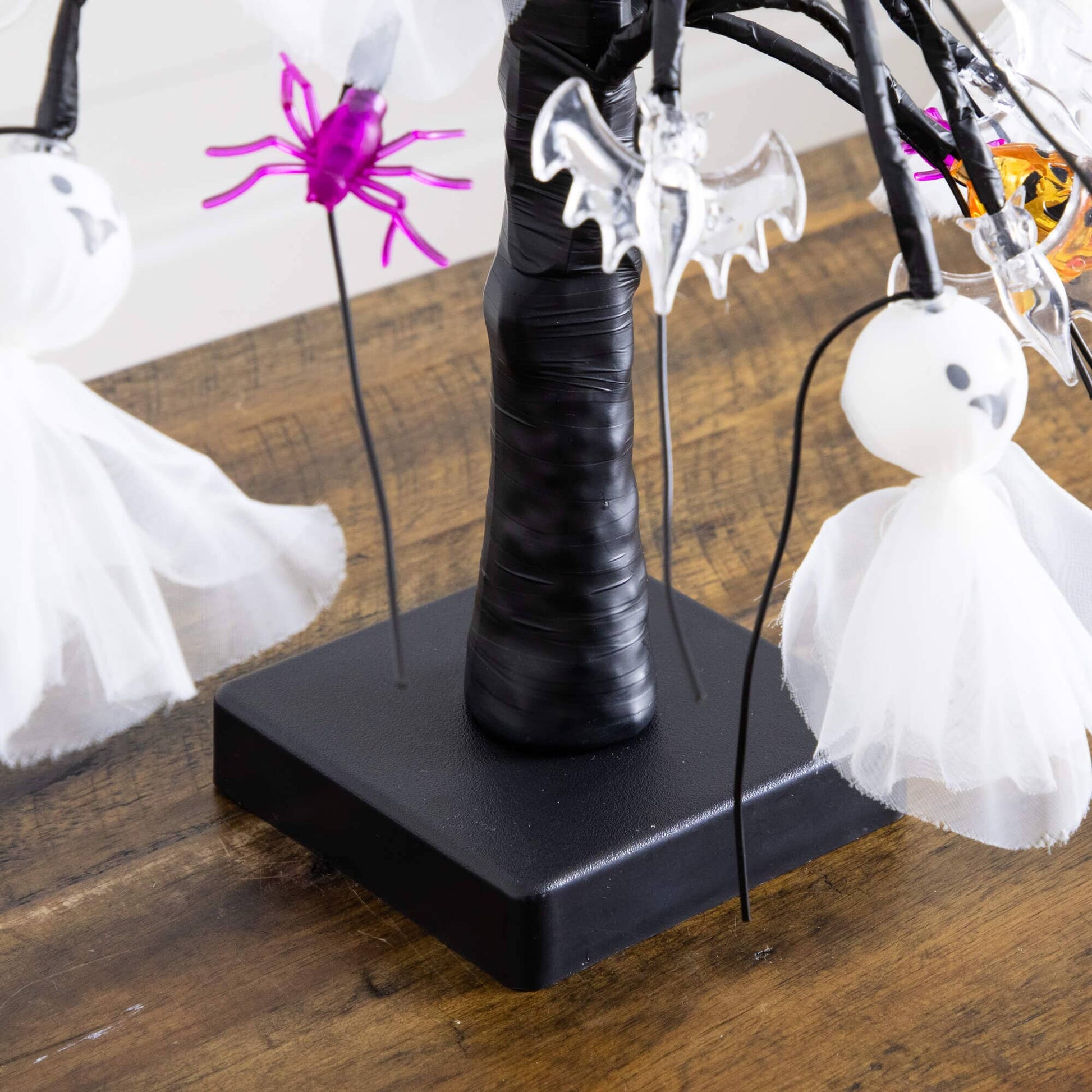 18in pre-lit Halloween ornament tree with white ghost dolls and pink spiders on a black trunk on Tampa Home & Garden Store