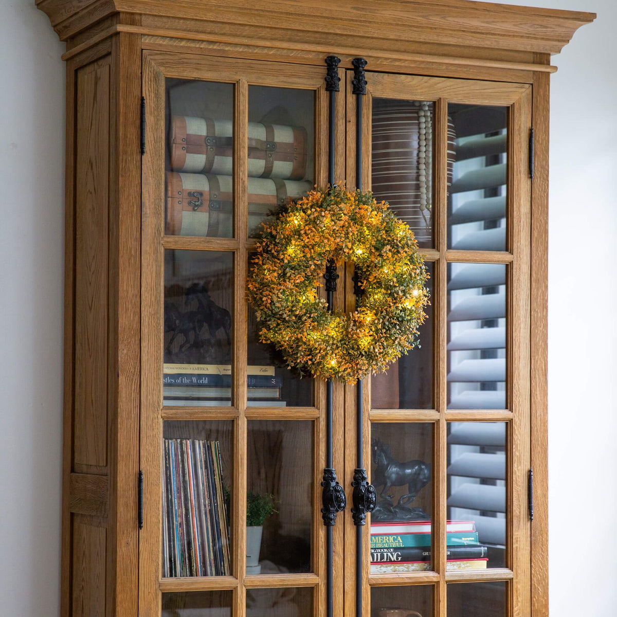 Nearly Natural 18in pre-lit autumn boxwood wreath with 25 warm LEDs in front of a glass cabinet on Tampa Home & Garden Store