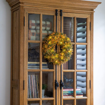 Nearly Natural 18in pre-lit autumn boxwood wreath with 25 warm LEDs in front of a glass cabinet on Tampa Home & Garden Store