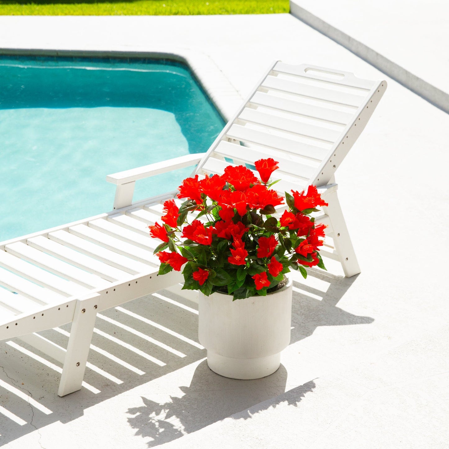 Artificial hibiscus bush with red blooms in a white planter by poolside UV resistant on Tampa Home & Garden Store