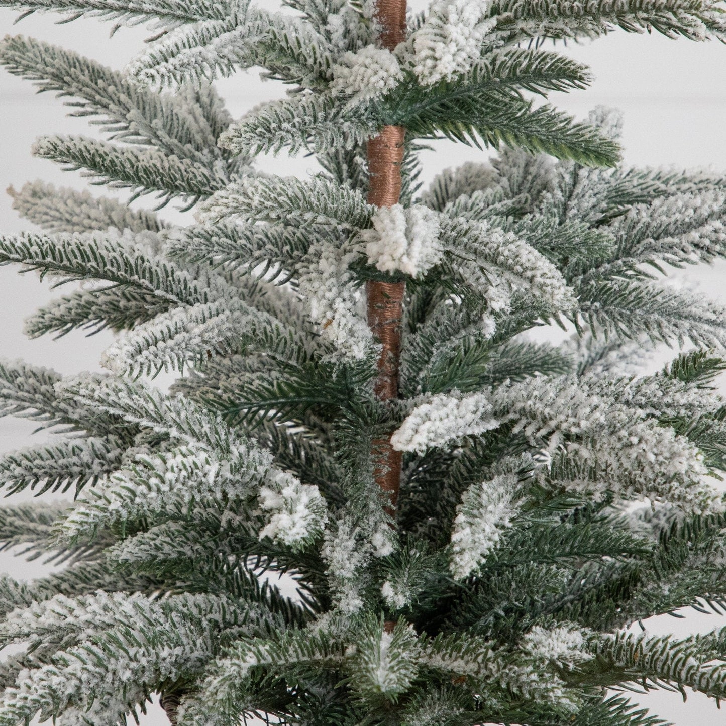 2ft artificial frosted Christmas tree with snow-dusted green needles and brown trunk on Tampa Home & Garden Store
