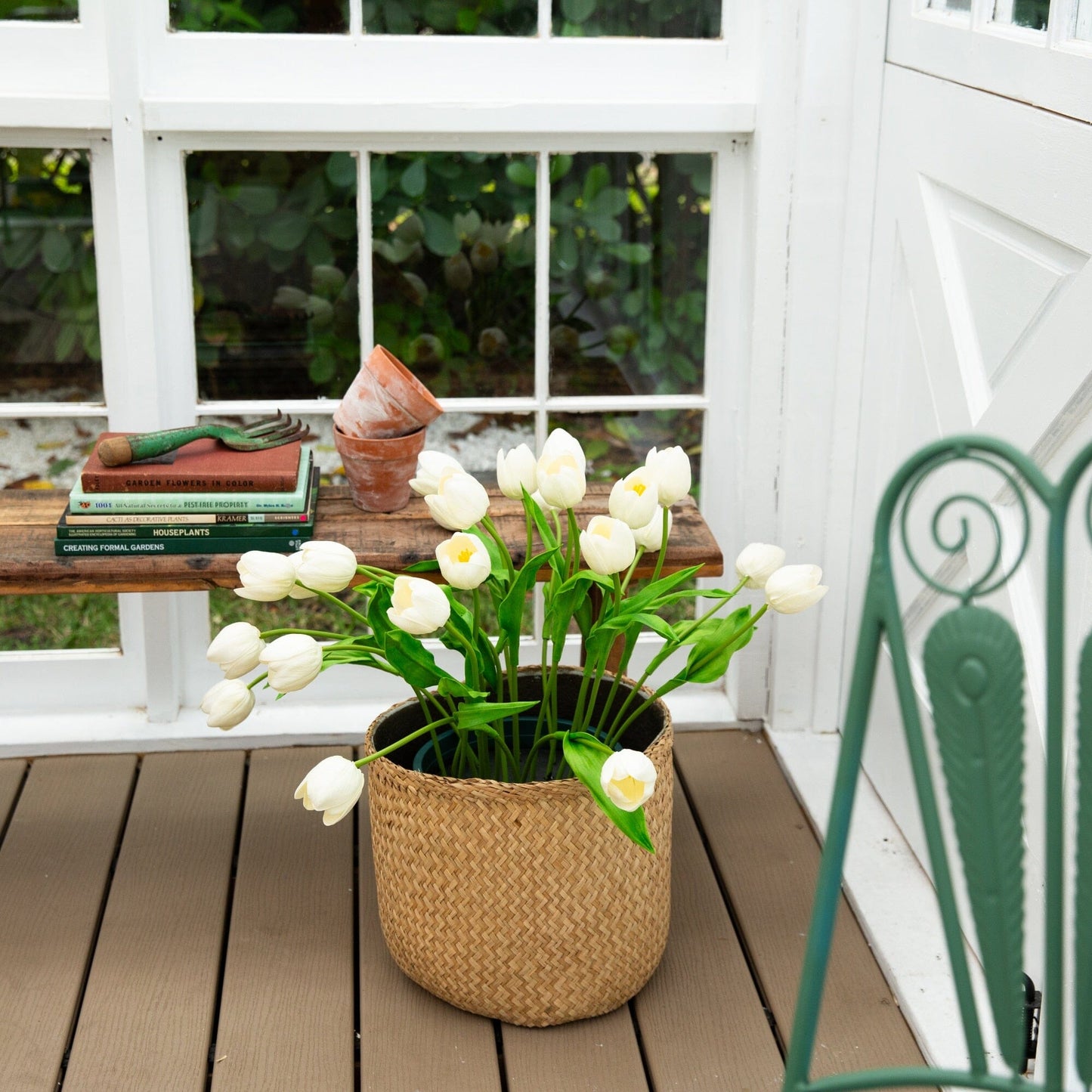 2' UV Resistant Artificial Tulip Plant in woven basket with white tulips on a wooden deck on Tampa Home & Garden Store