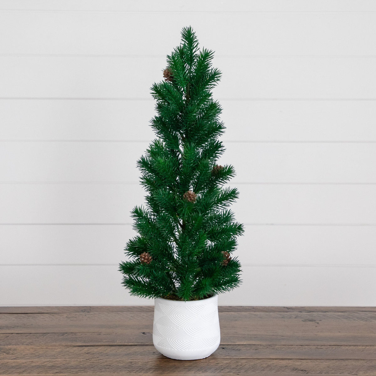 20” artificial Christmas tree with pinecones in a white ceramic planter on Tampa Home & Garden Store