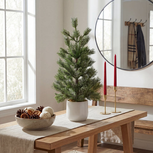 22-inch Nearly Natural frosted artificial Christmas tree in white ceramic planter on a wooden table on Tampa Home & Garden Store