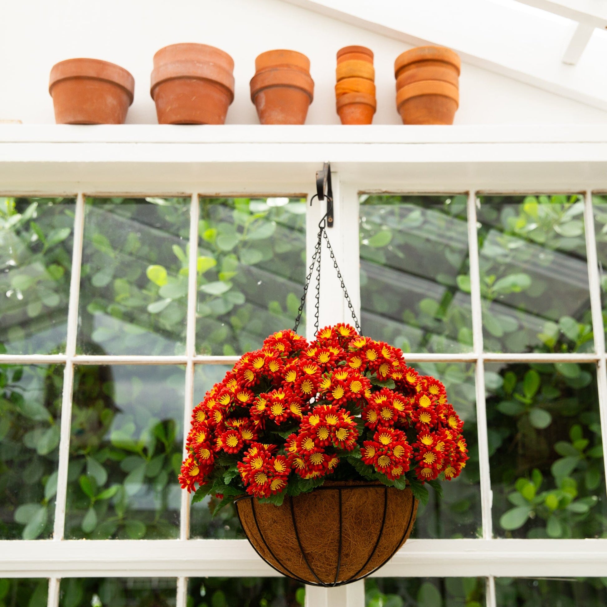 Artificial chrysanthemum hanging basket 24in with UV resistant red orange blooms in wicker on Tampa Home & Garden Store