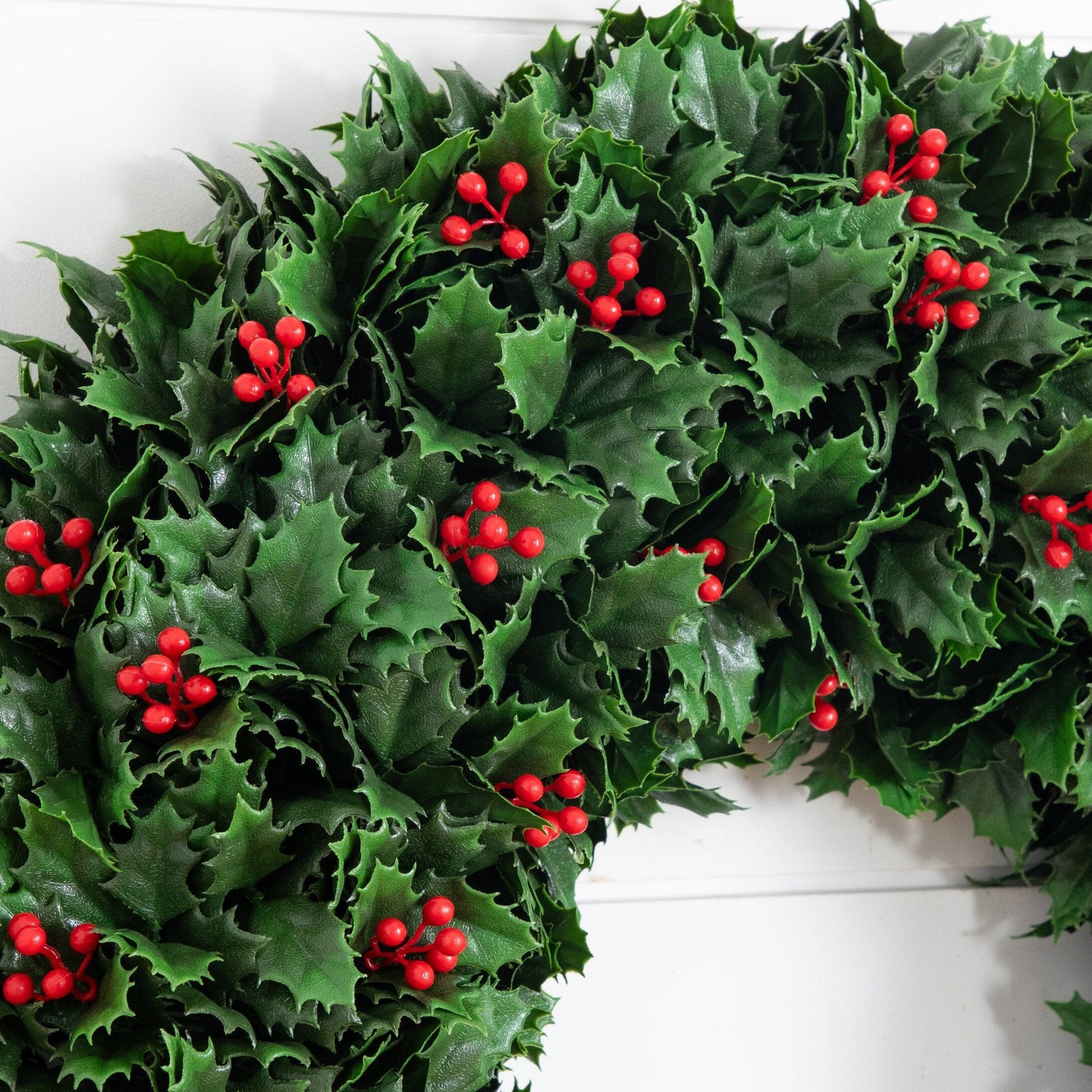 24in UV-resistant artificial holly berry wreath with green leaves and red berries on Tampa Home & Garden Store