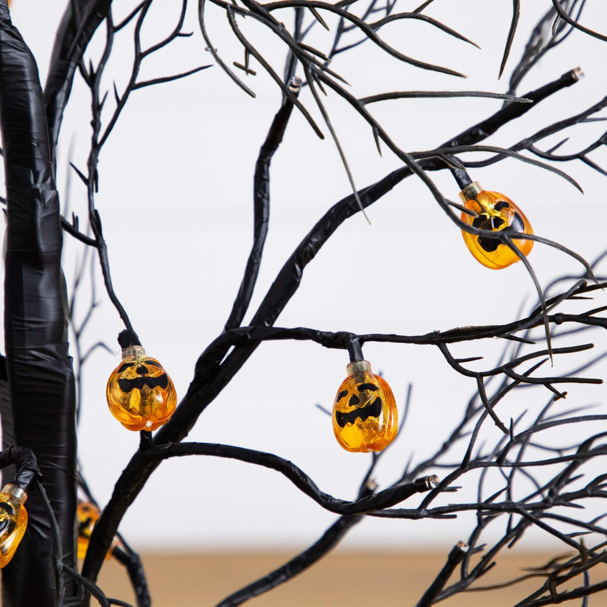 Nearly Natural 3' black twig Halloween tree with 18 orange pumpkin-shaped LED lights on Tampa Home & Garden Store