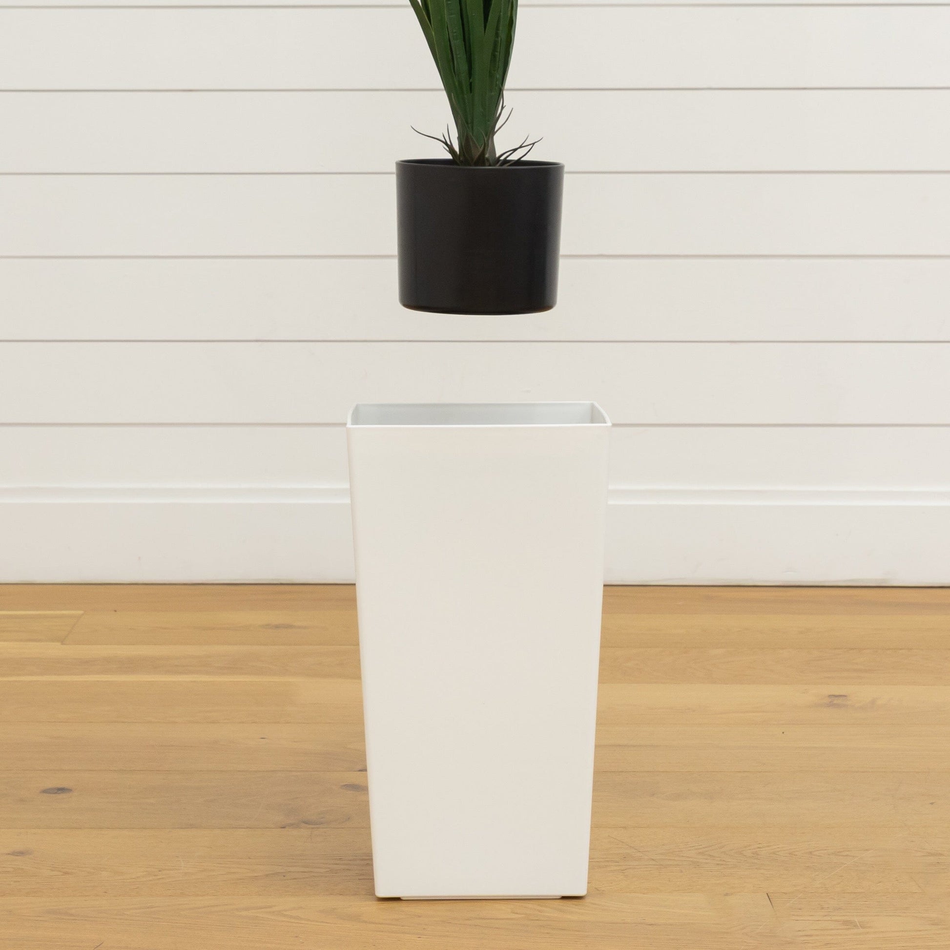 Artificial grass plant in black cylindrical planter with dense green blades on Tampa Home & Garden Store