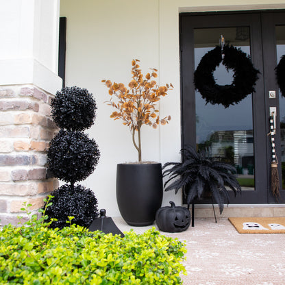 3' UV Resistant Halloween Black Boxwood Topiary in a black planter on porch with orange plant on Tampa Home & Garden Store