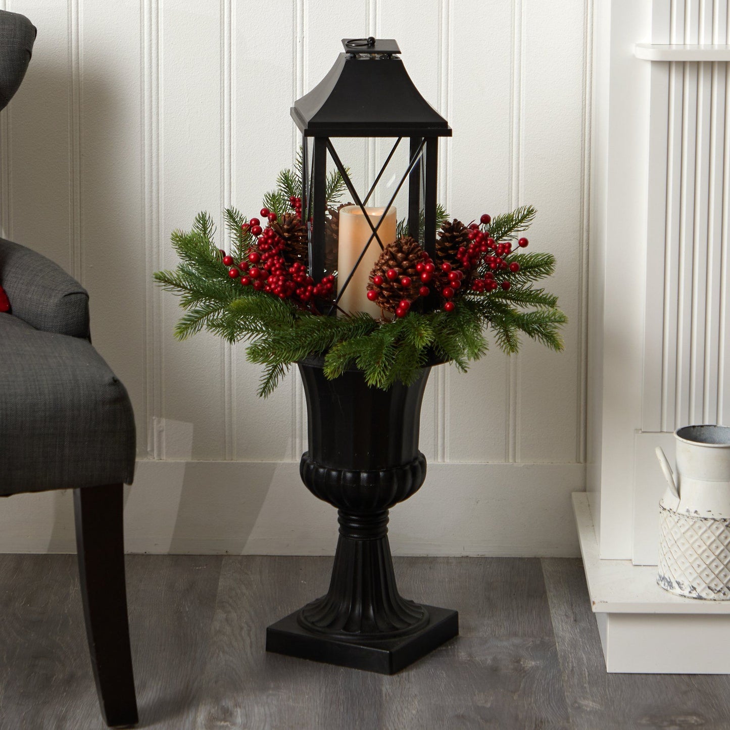 33” Holiday greenery with red berries and pinecones around a candle in a black lantern urn on Tampa Home & Garden Store