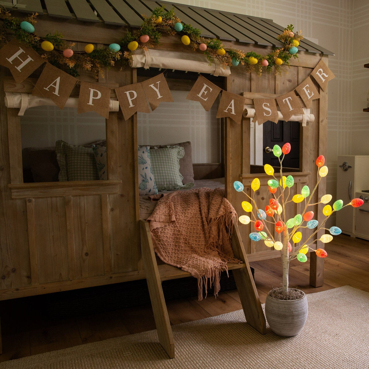 3' pre-lit Easter twig tree with 40 egg-shaped LED ornaments, eggs near burlap banner on Tampa Home & Garden Store