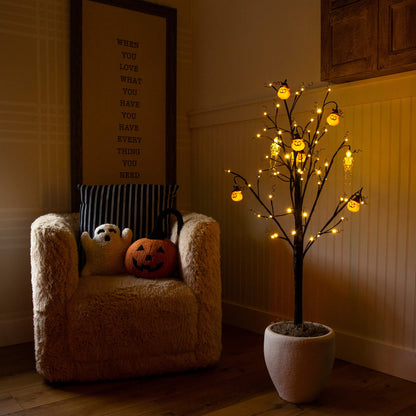 4' Pre-Lit Halloween Pumpkins and Skulls Ornament Tree with 64 warm LEDs in a room with pumpkins on Tampa Home & Garden Store