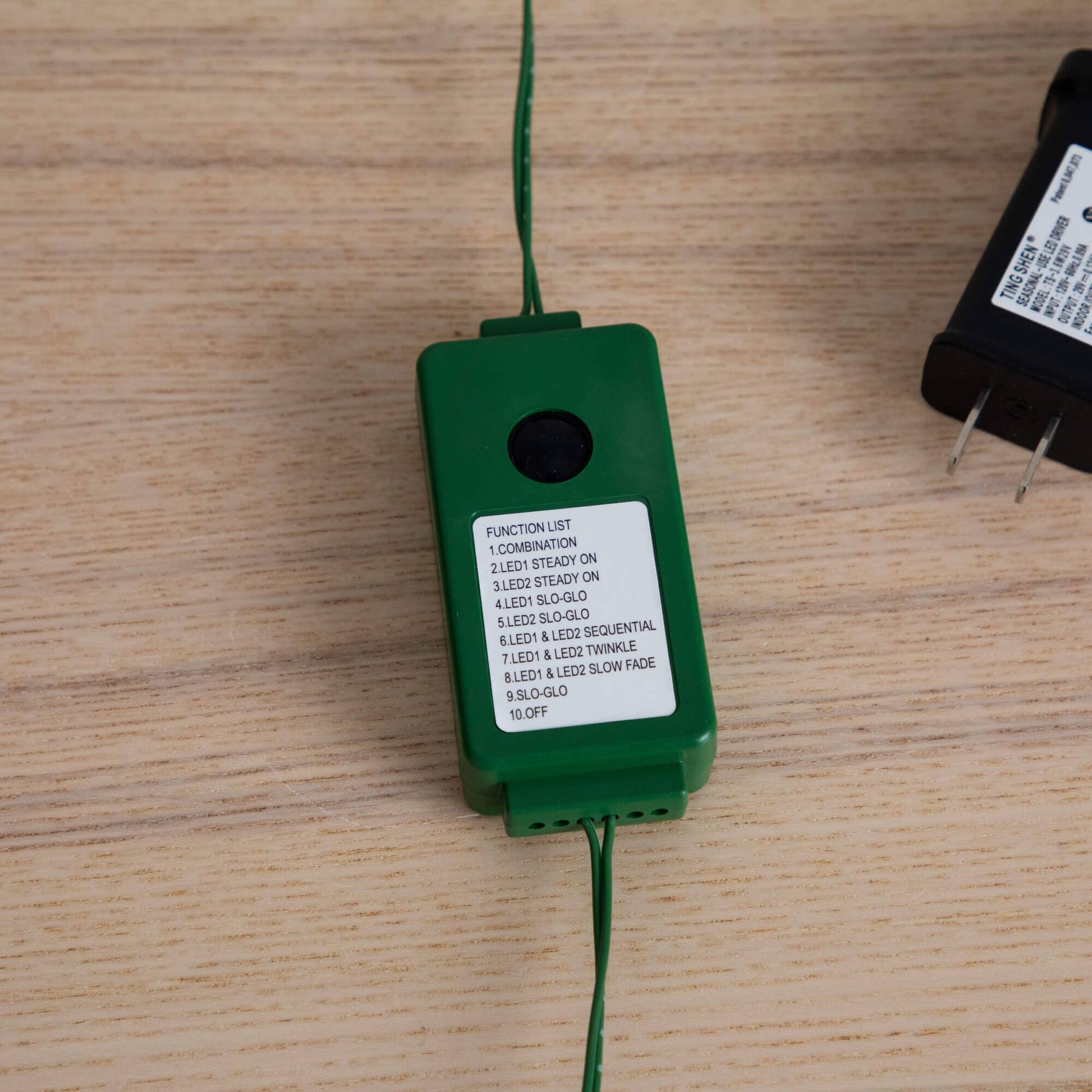 Tree light controller box, green plastic with function list on wood surface Nearly Natural on Tampa Home & Garden Store