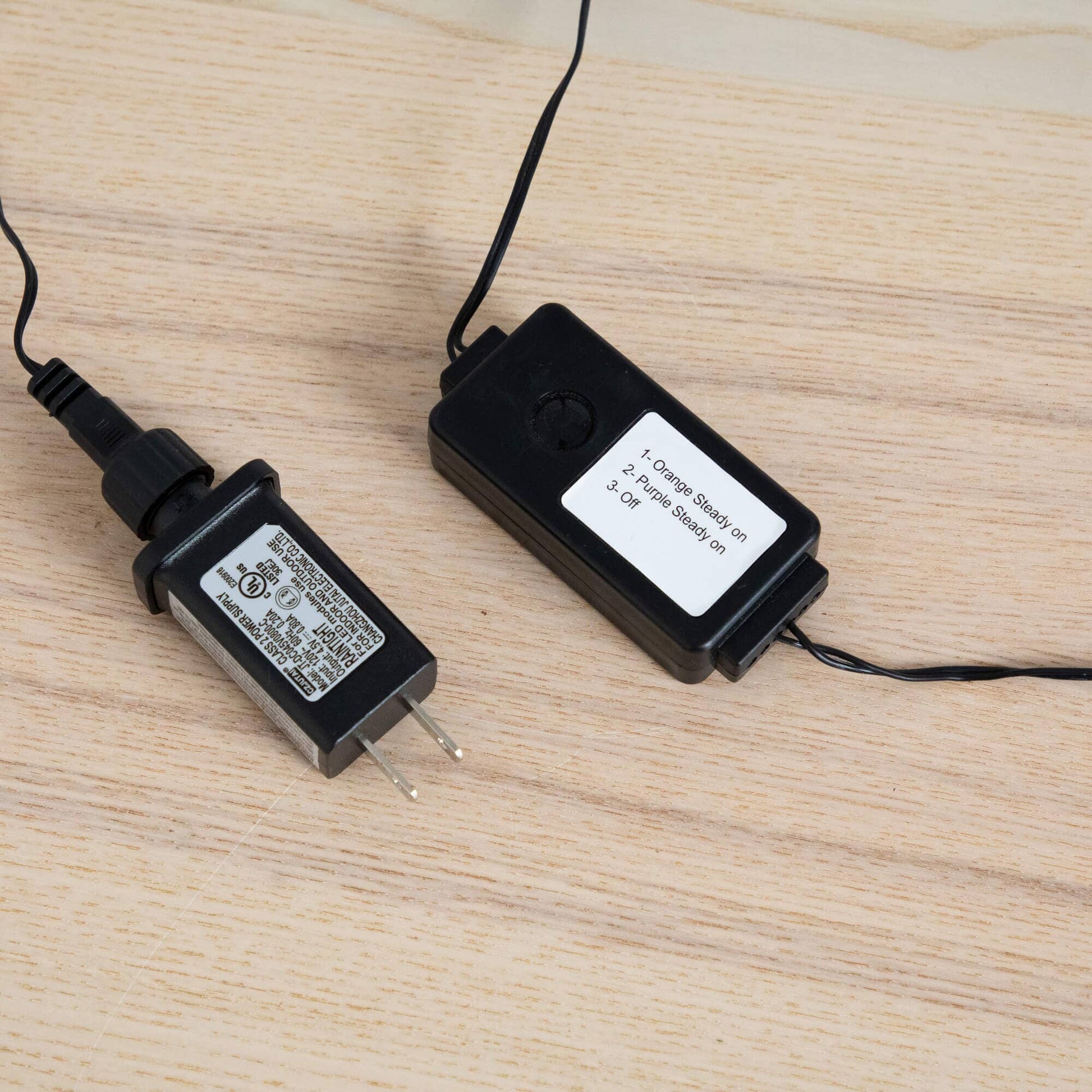 4' Pre-Lit Halloween Black Twig Tree power adapters and cords on a wood surface on Tampa Home & Garden Store