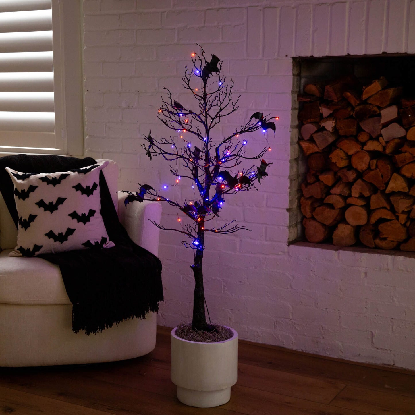 4 ft black Halloween twig tree with bats and orange-purple LED lights in white planter on Tampa Home & Garden Store