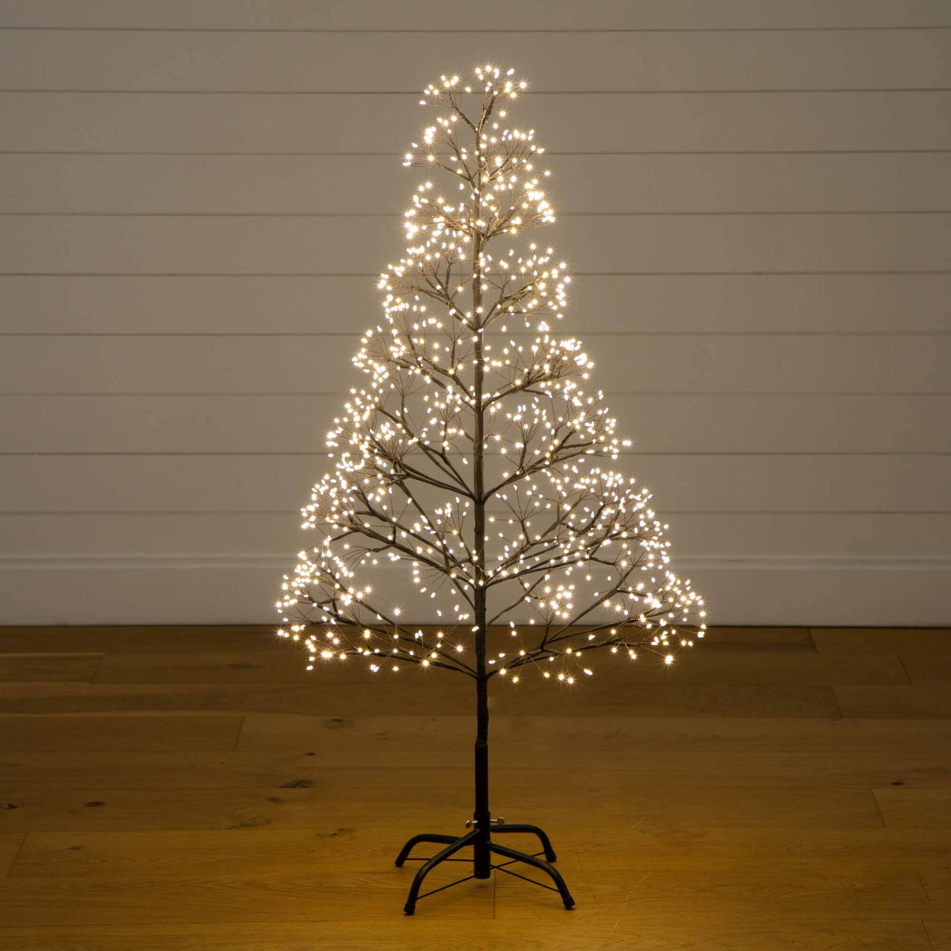4' pre-lit artificial Halloween black starburst tree with 800 warm white LEDs on a stand on Tampa Home & Garden Store