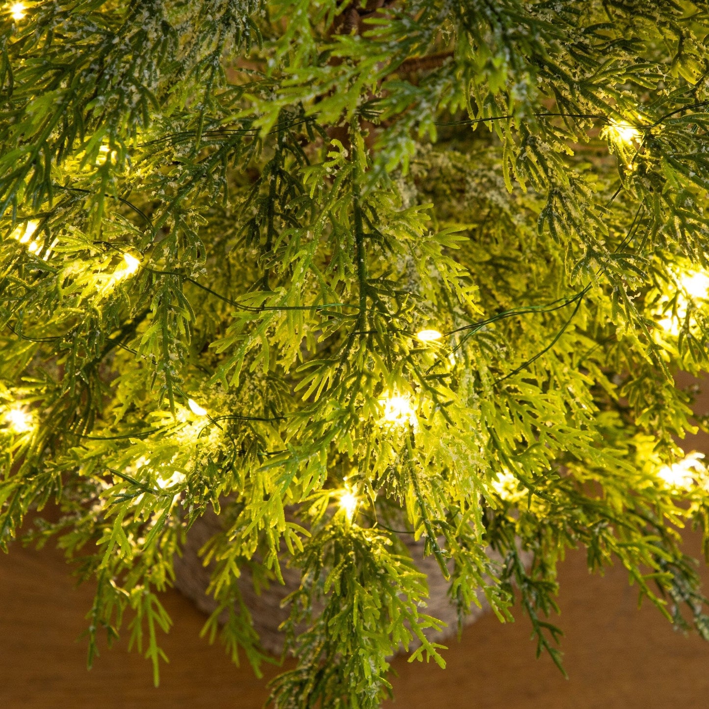 4 ft pre-lit artificial snowed cypress tree close-up with green needles and warm LEDs on Tampa Home & Garden Store