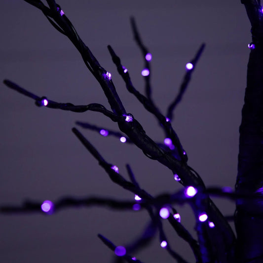Pre-Lit Halloween Twig Tree with purple LED lights close-up on dark background on Tampa Home & Garden Store