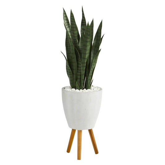 Sansevieria artificial plant in white ceramic planter with white pebbles on a wooden tripod on Tampa Home & Garden Store
