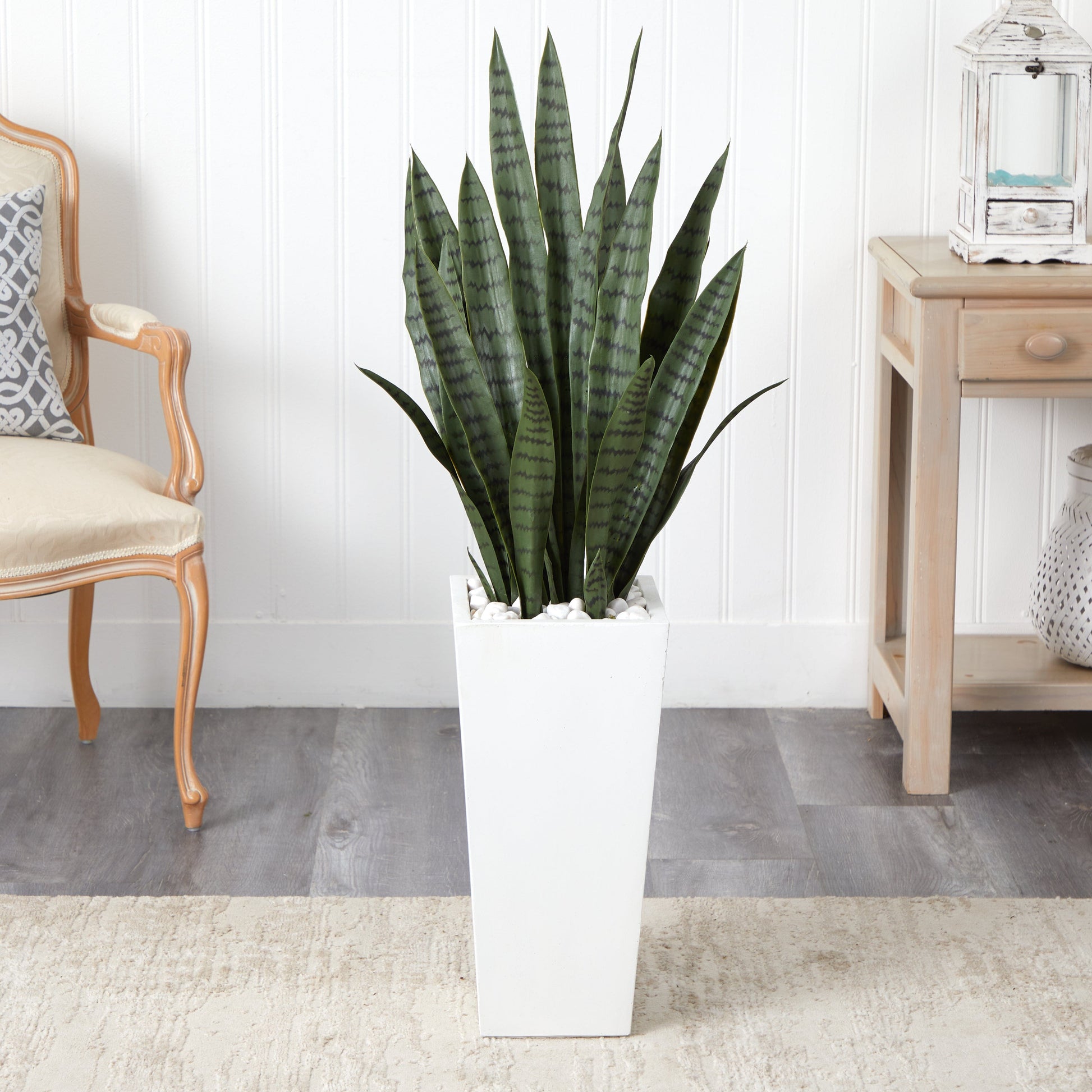 4’ Sansevieria artificial plant in a white tower planter with white decorative stones on Tampa Home & Garden Store