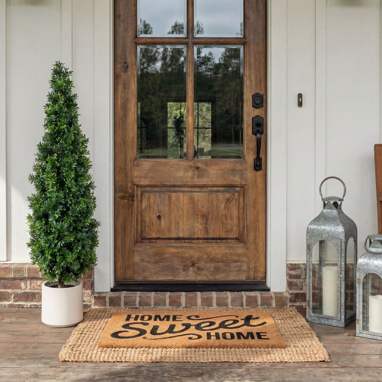 44in UV-resistant artificial boxwood topiary cone tree in planter with two lanterns by door on Tampa Home & Garden Store