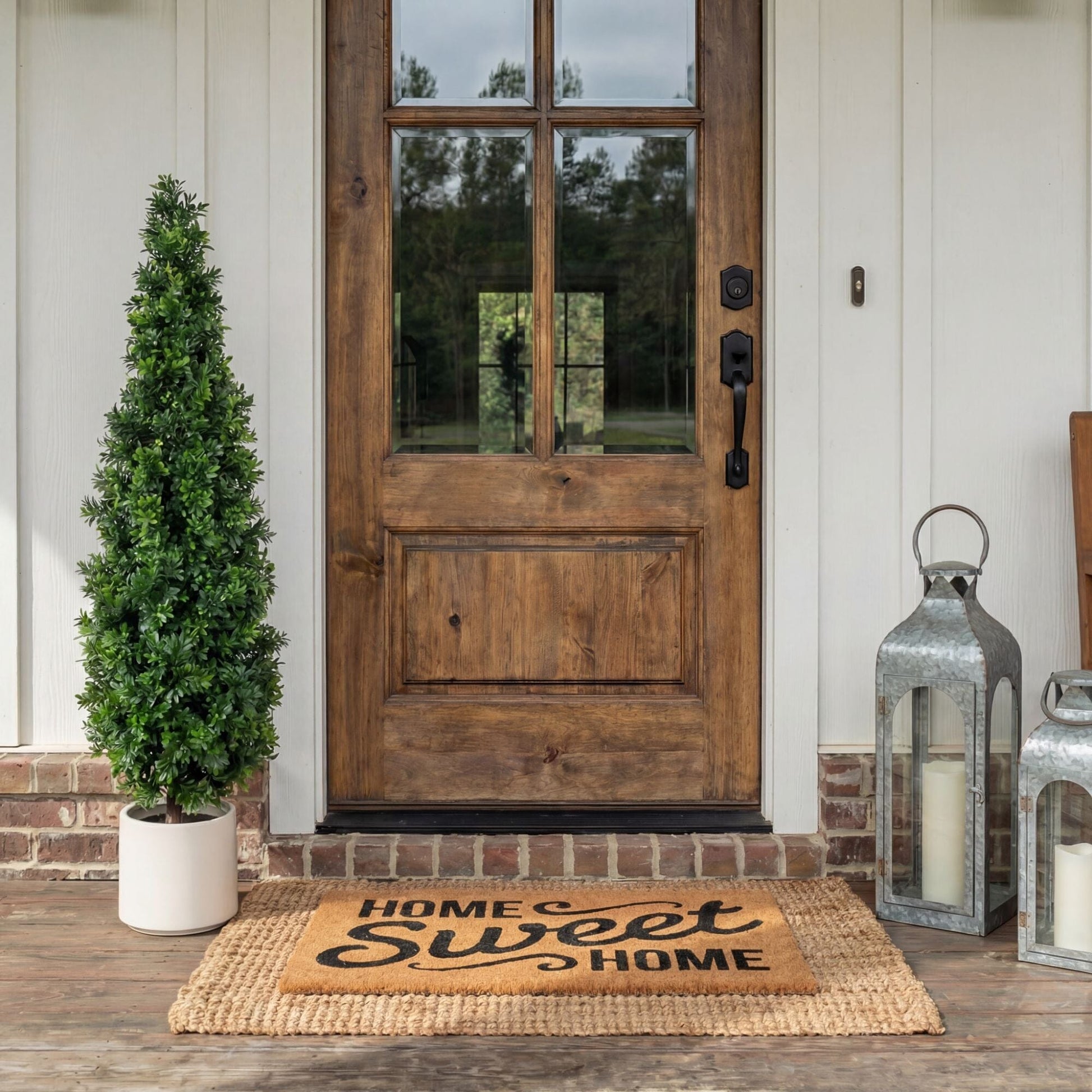 44in UV-resistant artificial boxwood topiary cone tree in planter with two lanterns by door on Tampa Home & Garden Store