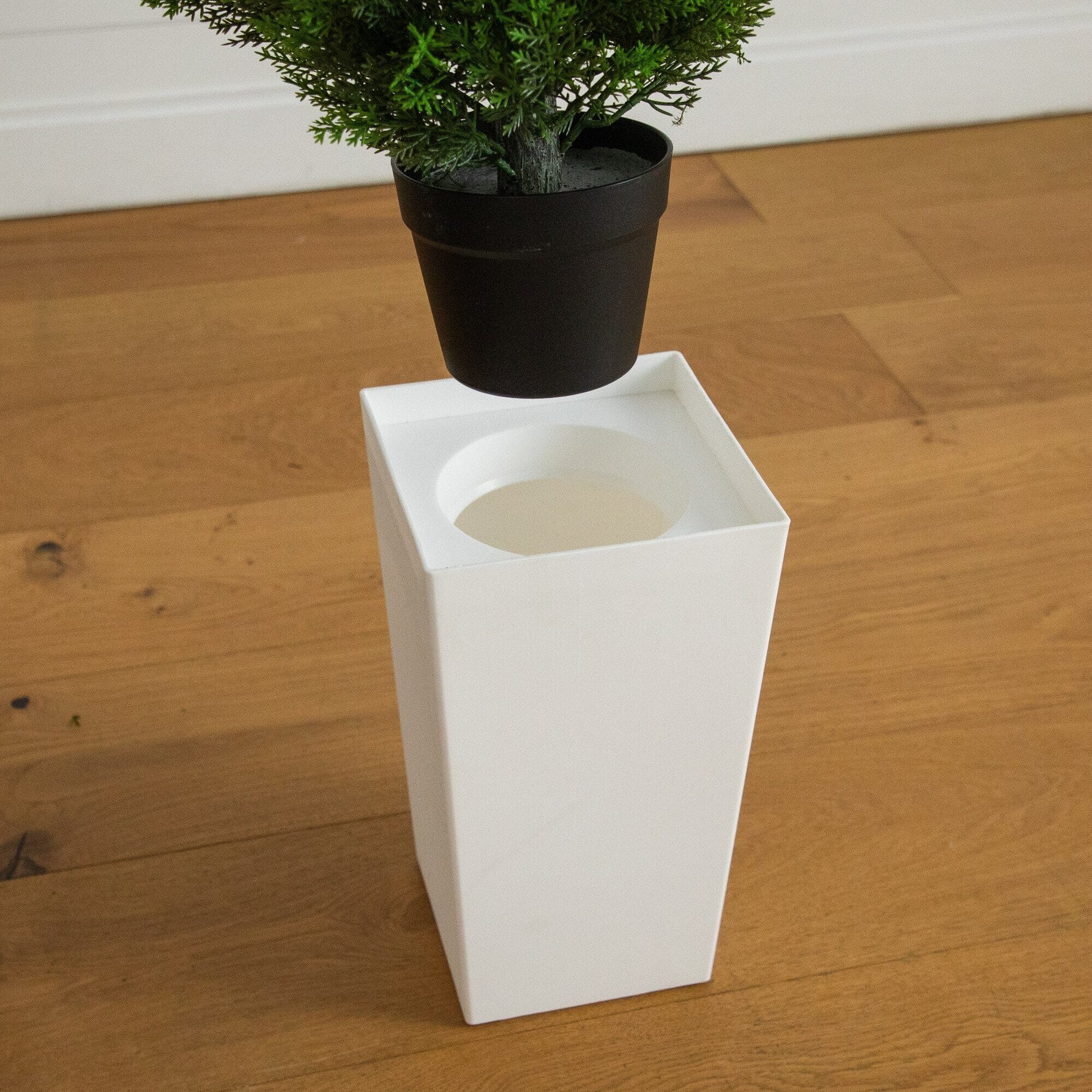 Nearly Natural 45in UV resistant artificial cedar tree in black planter on white display base on Tampa Home & Garden Store