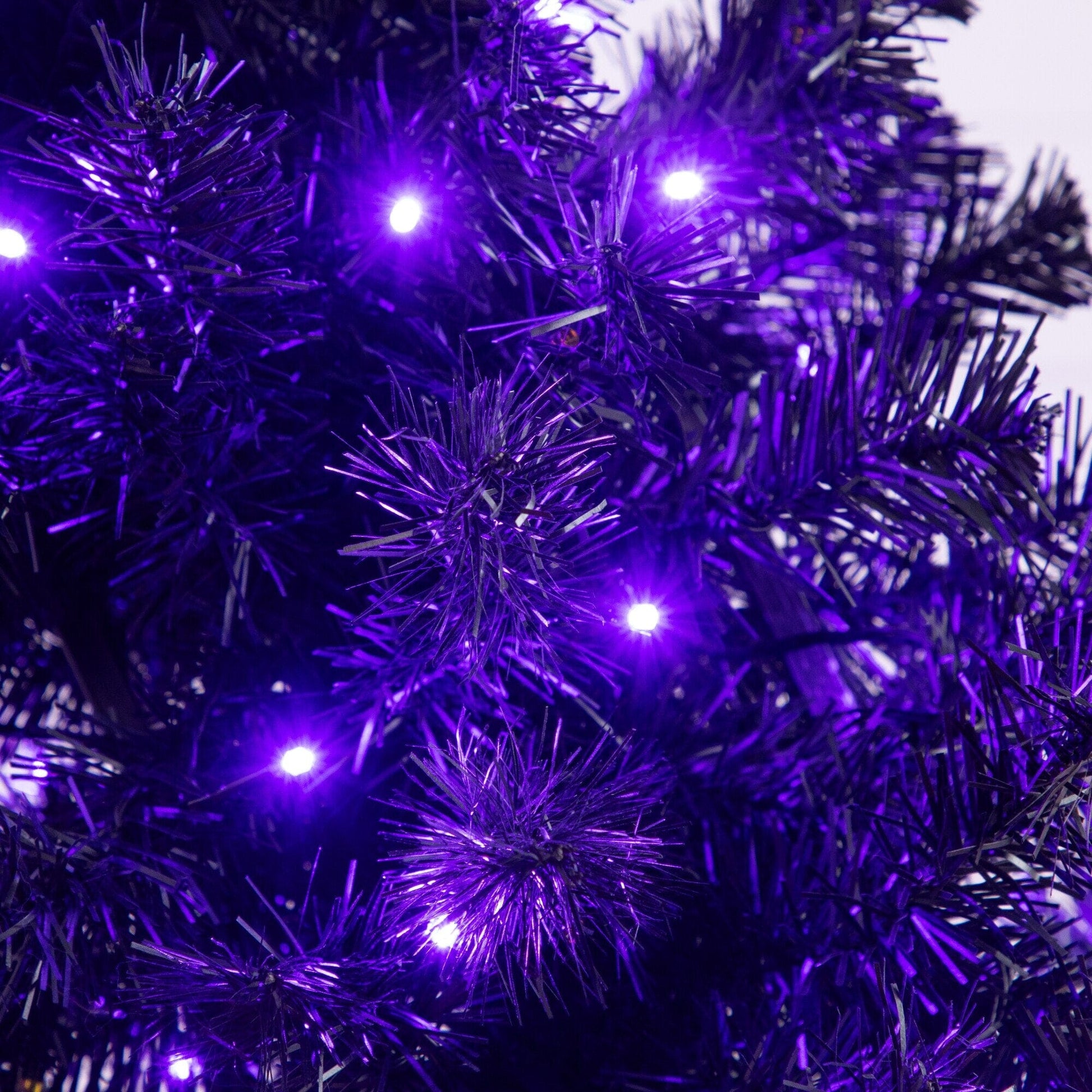 4 ft pre-lit Halloween tree with purple and orange LEDs and a black moon skull design on Tampa Home & Garden Store