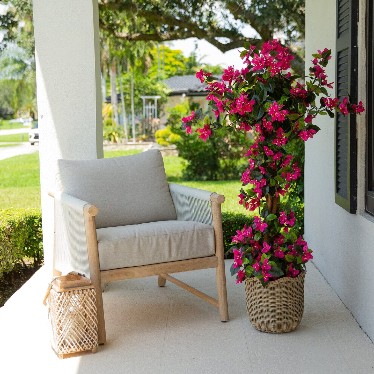 4 ft UV resistant artificial spiral bougainvillea tree with blooms in wicker planter on porch on Tampa Home & Garden Store