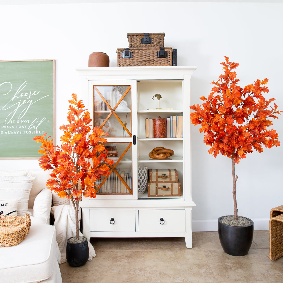 Nearly Natural 5’ Autumn Oak artificial fall tree with orange leaves in a pot beside cabinet on Tampa Home & Garden Store