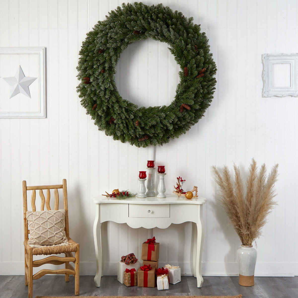 Nearly Natural 5 ft flocked wreath with pinecones and 680 bendable branches on white paneled wall on Tampa Home & Garden Store