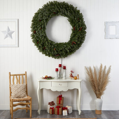 Nearly Natural 5 ft flocked wreath with pinecones and 680 bendable branches on white paneled wall on Tampa Home & Garden Store