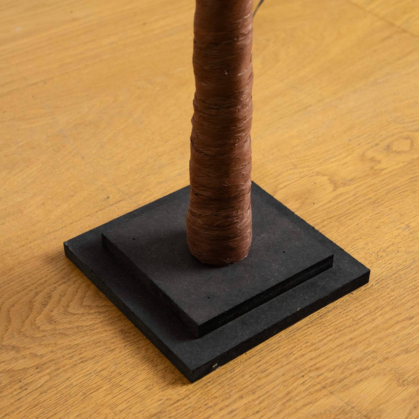 5 ft pre-lit autumn artificial tree trunk wrapped in brown tape on black display base on Tampa Home & Garden Store