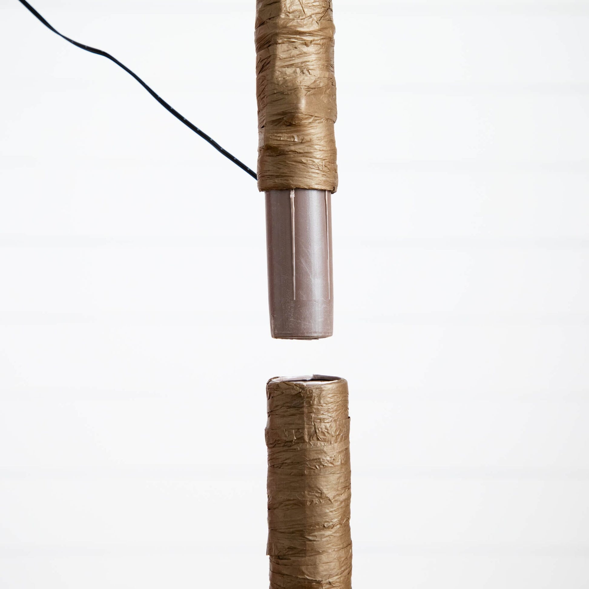 5 ft pre-lit artificial tree trunk close-up with brown wrapping and visible wire on Tampa Home & Garden Store
