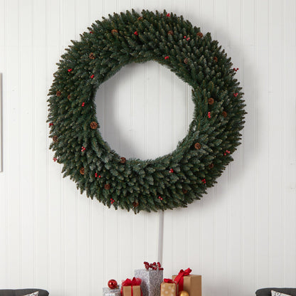 5 ft large green flocked wreath with pinecones and red berries on white paneled wall on Tampa Home & Garden Store