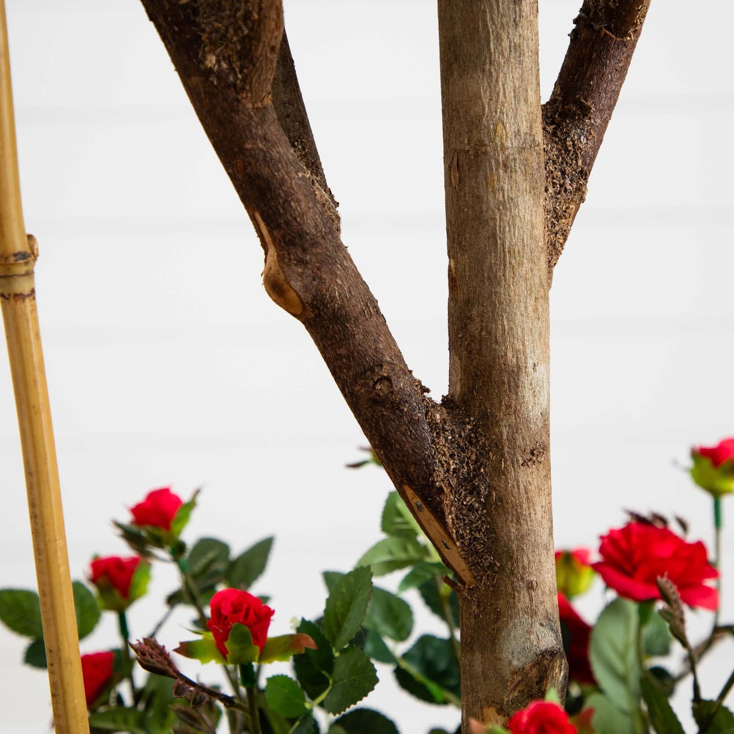 Nearly Natural 5' Mini Rose Silk Tree trunk detail with red silk roses in background on Tampa Home & Garden Store