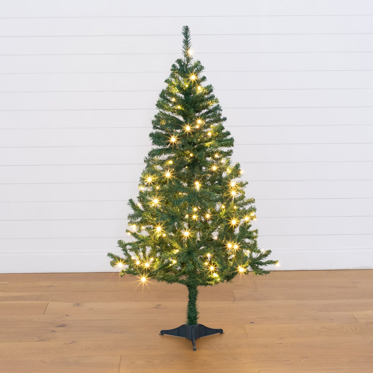 5' Northern Tip Pine artificial Christmas tree with 150 LED lights, green needles on black stand on Tampa Home & Garden Store