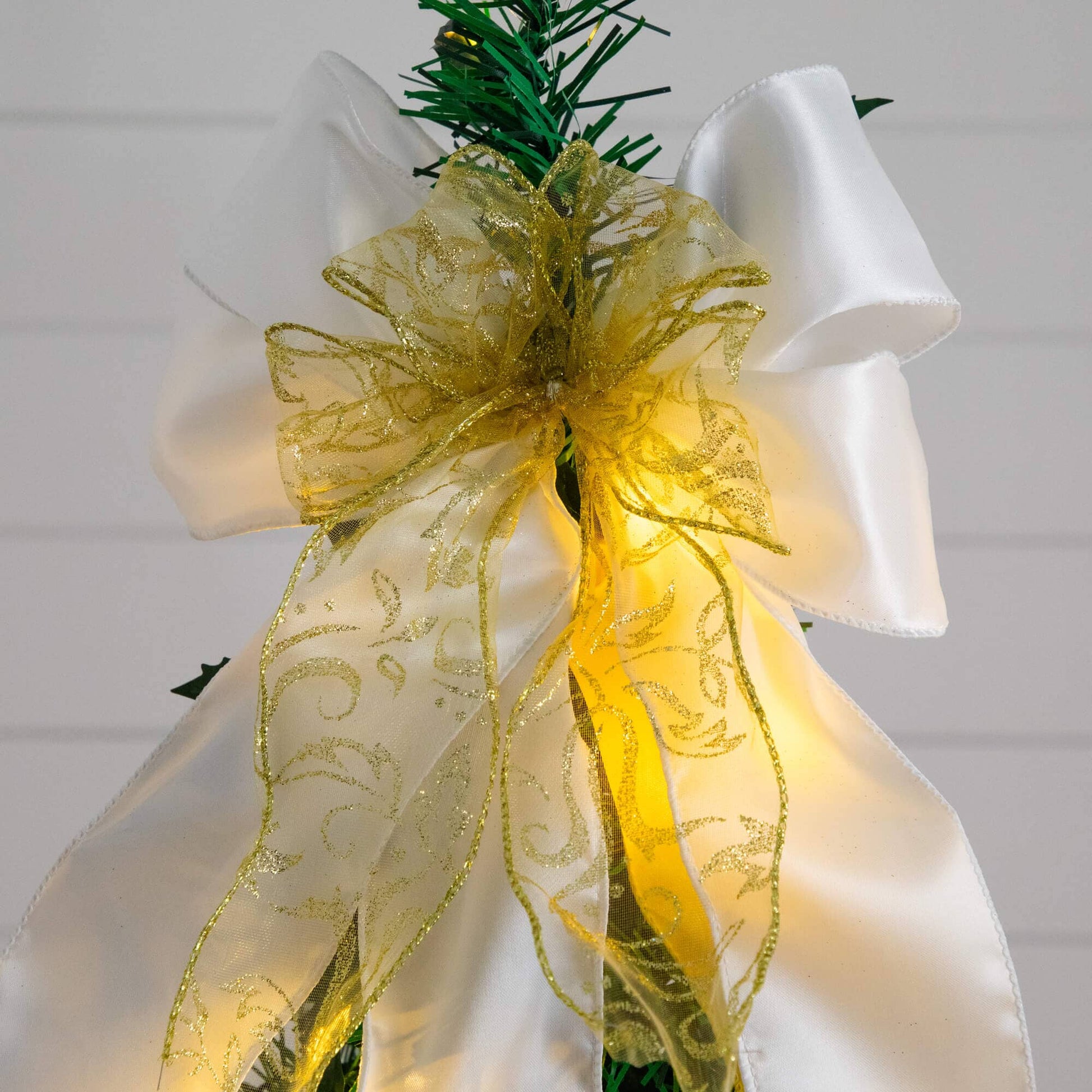 Nearly Natural 5 ft pre-lit pop-up Christmas tree wrapped in white satin with gold glitter ribbon bow on Tampa Home & Garden Store